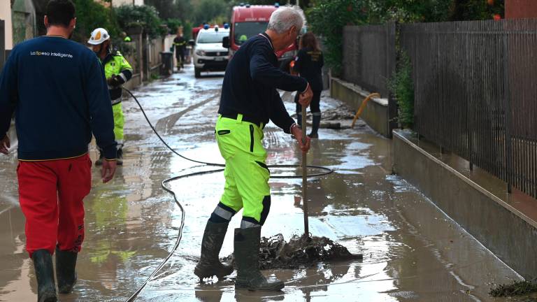 Un operatore al lavoro per liberare un tombino dopo un allagamento (foto Blaco)